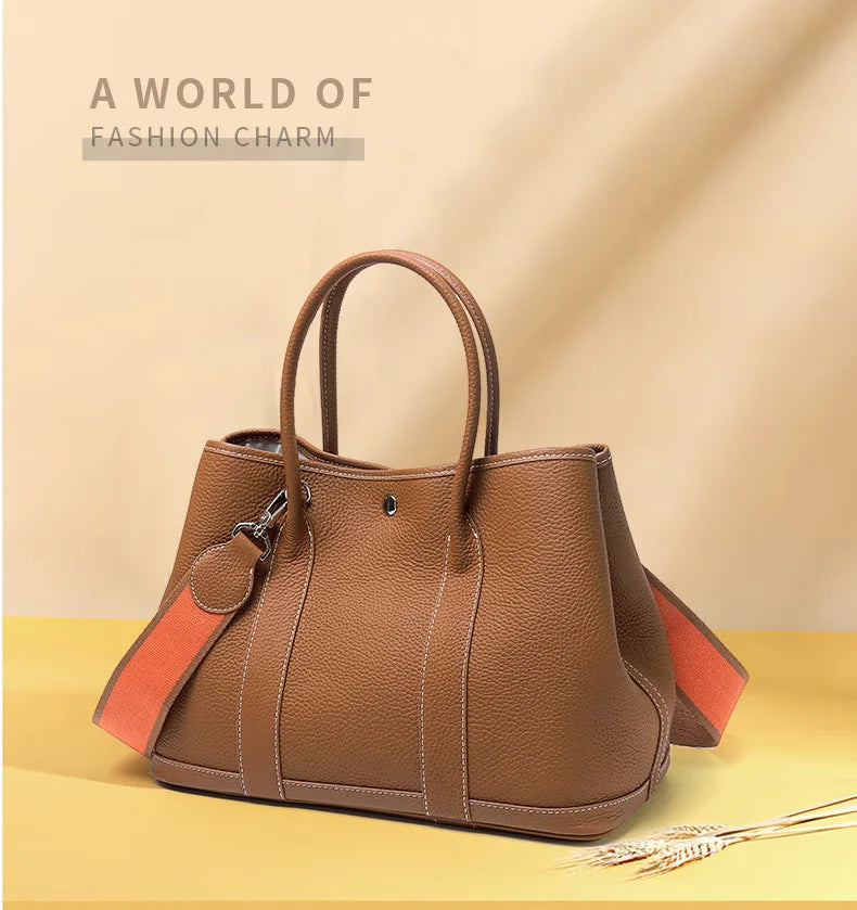 Brown handbag with orange interior on a beige background