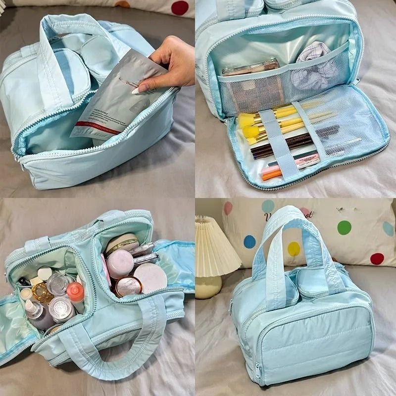 Light blue travel bag with compartments filled with items on a bed.