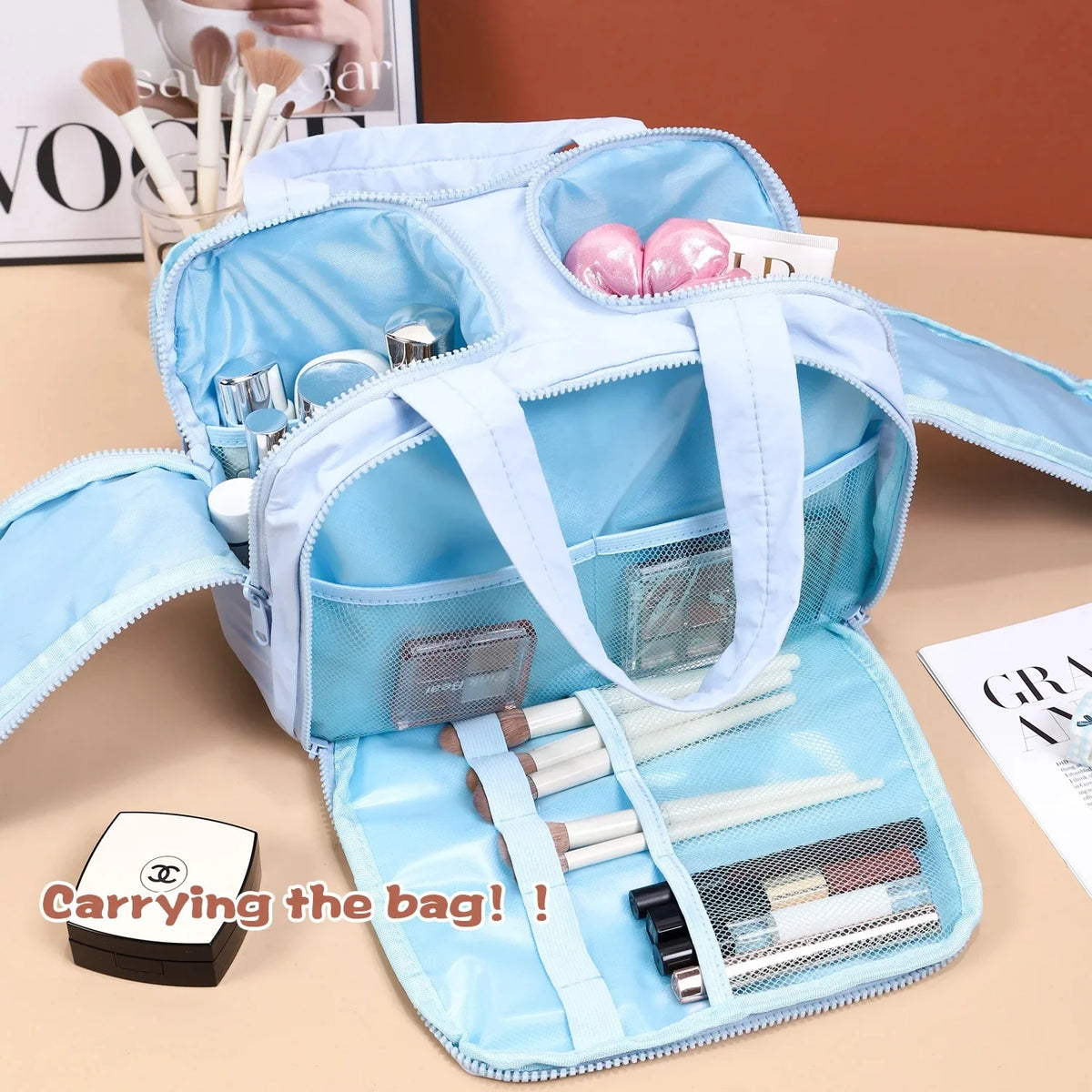 Blue cosmetic bag with makeup items on a table