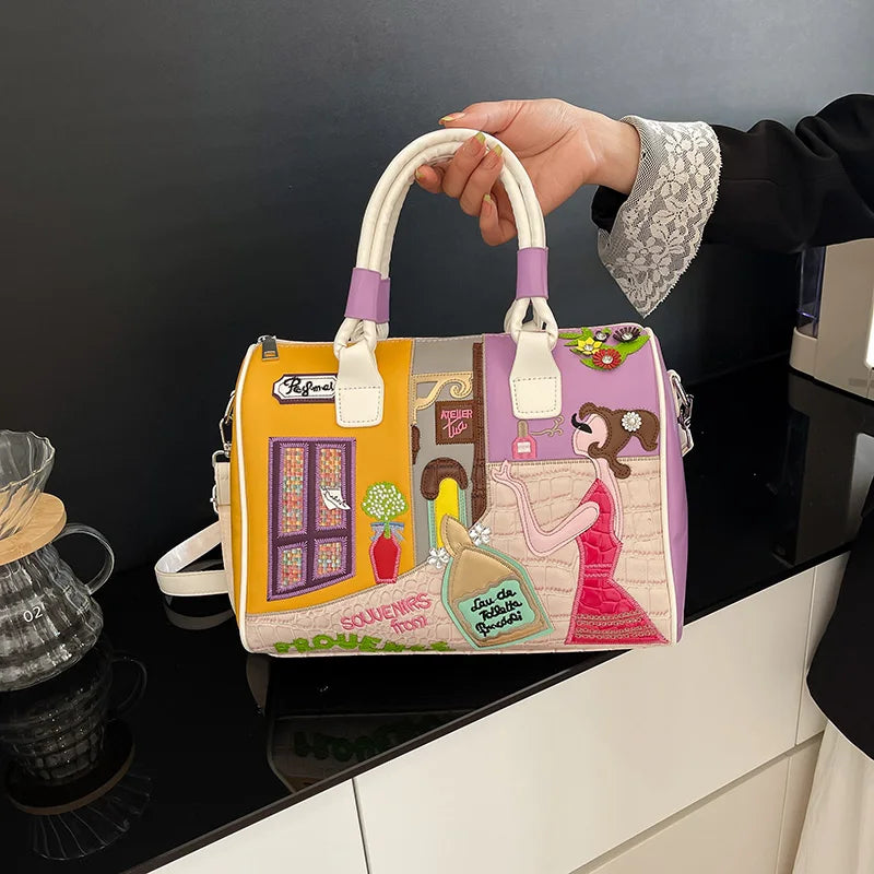 Colorful handbag with artistic design held by a person in a kitchen setting