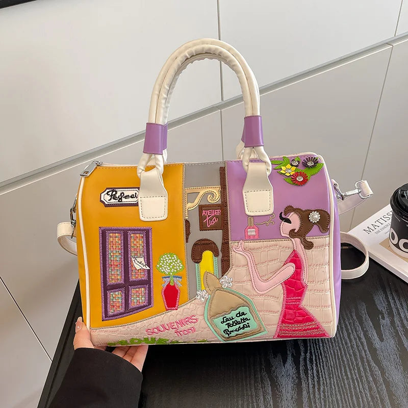 Colorful handbag with artistic design held by a person against a neutral background