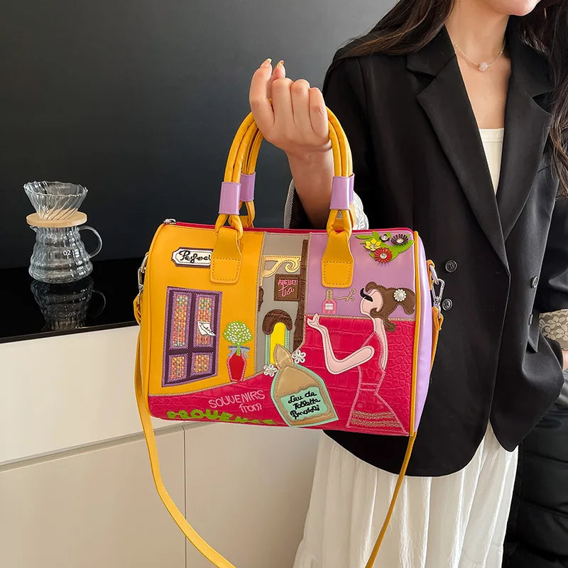 Person holding a colorful handbag with artistic designs on a neutral background