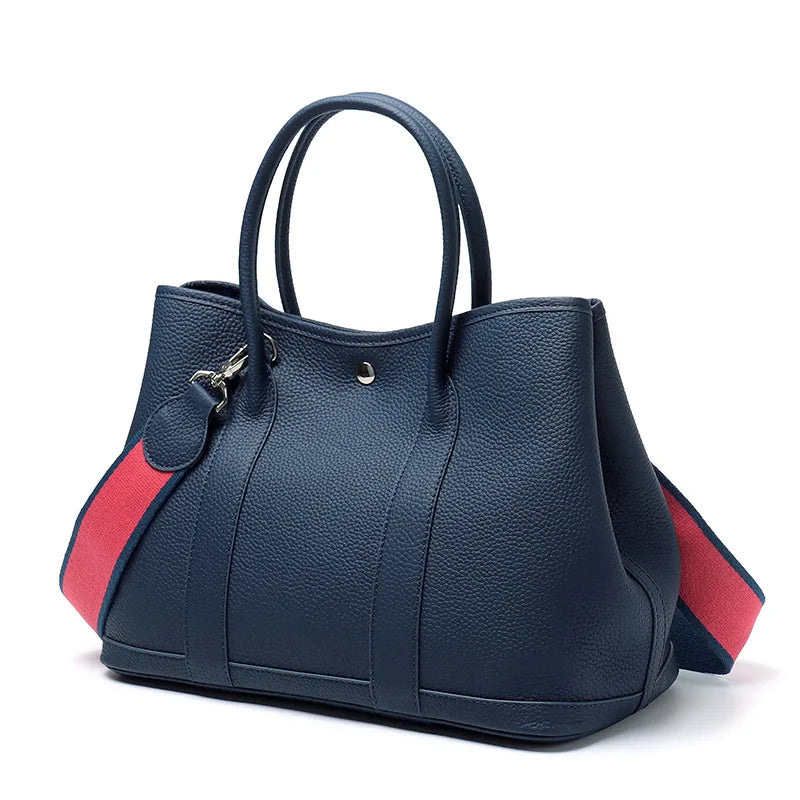 Blue handbag with red accents on a white background
