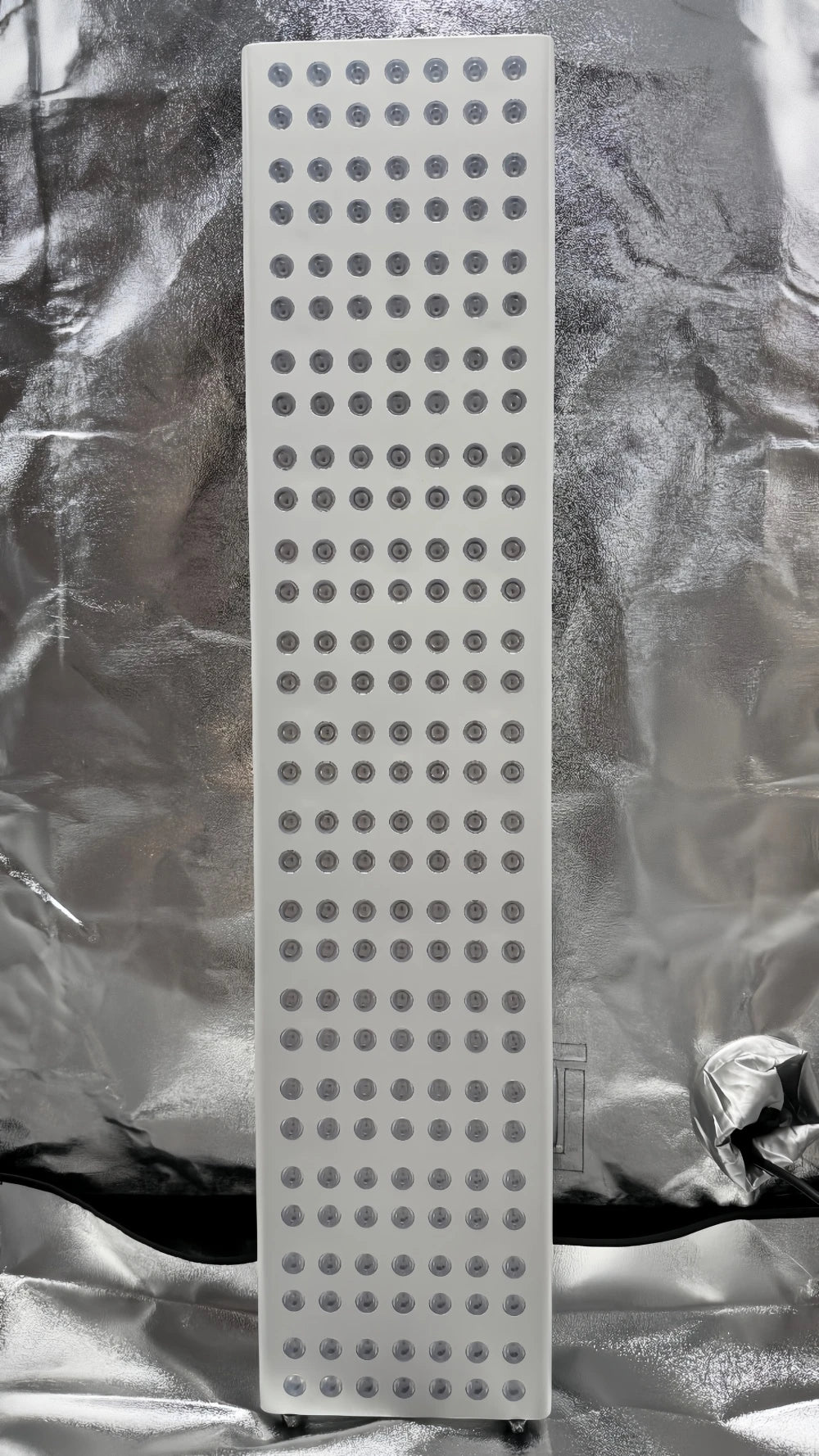 Rectangular sanding block with a grid pattern on a textured silver background