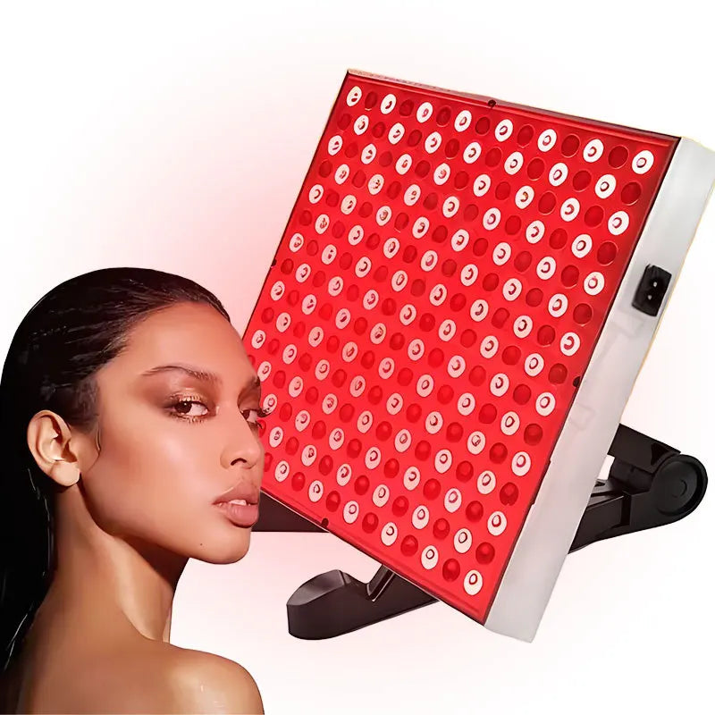 Woman with a red LED light panel on a white background