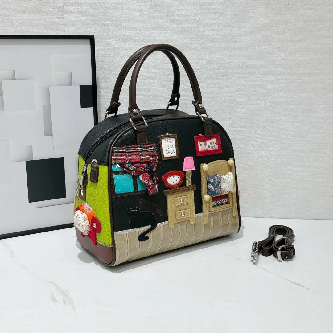 Handbag with decorative patches resembling a room on a white surface