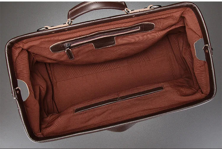 Brown leather briefcase with open lid on a gray background