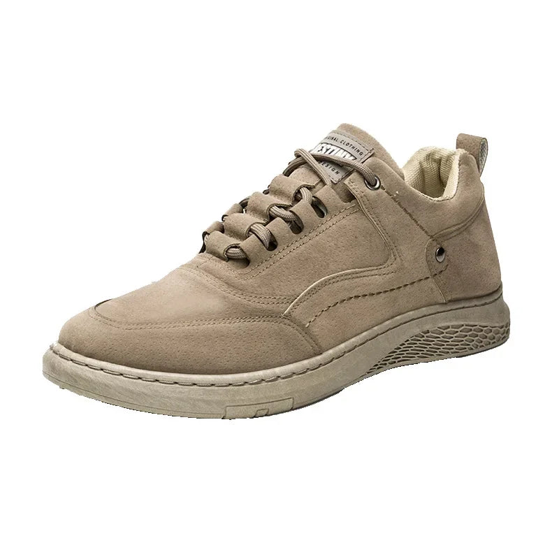 A single mid-top casual sneaker in a light taupe-beige suede-like material, featuring matching laces, metal eyelets, and a thick textured sole, shown against a plain white background.