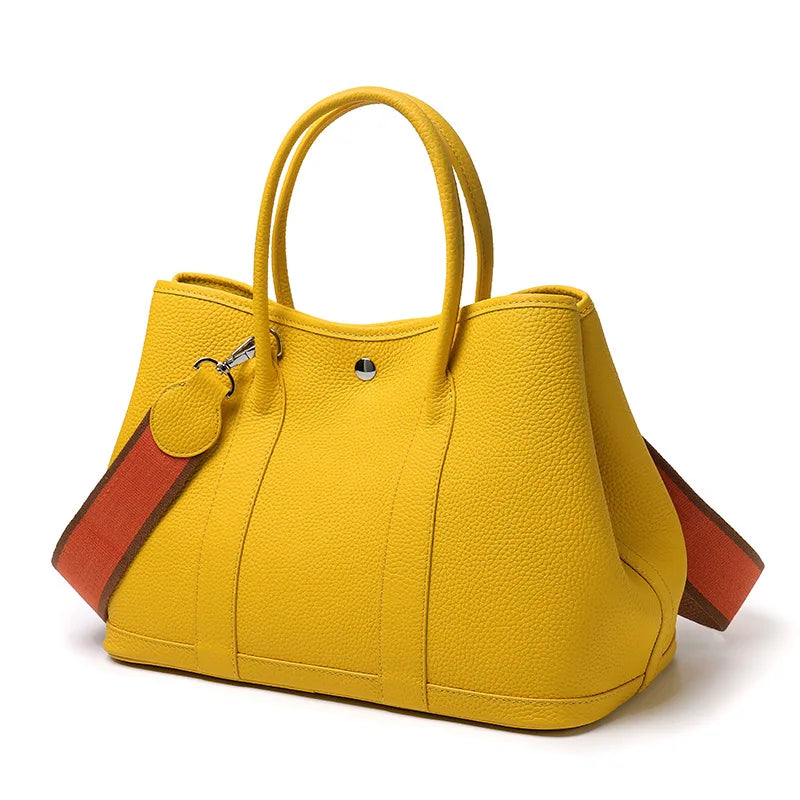 Yellow handbag with brown accents on a white background
