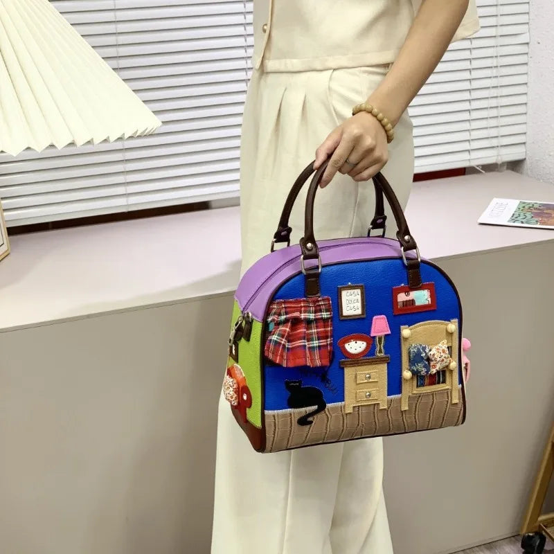 Colorful handbag with decorative elements held by a person indoors.