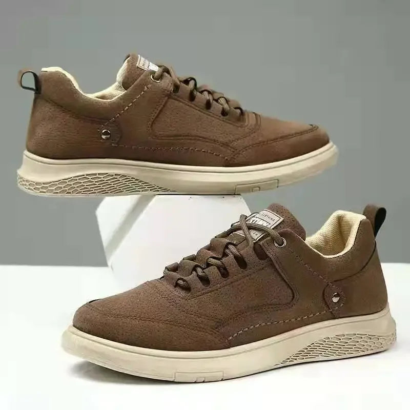 Brown sneakers with white soles on a gray background