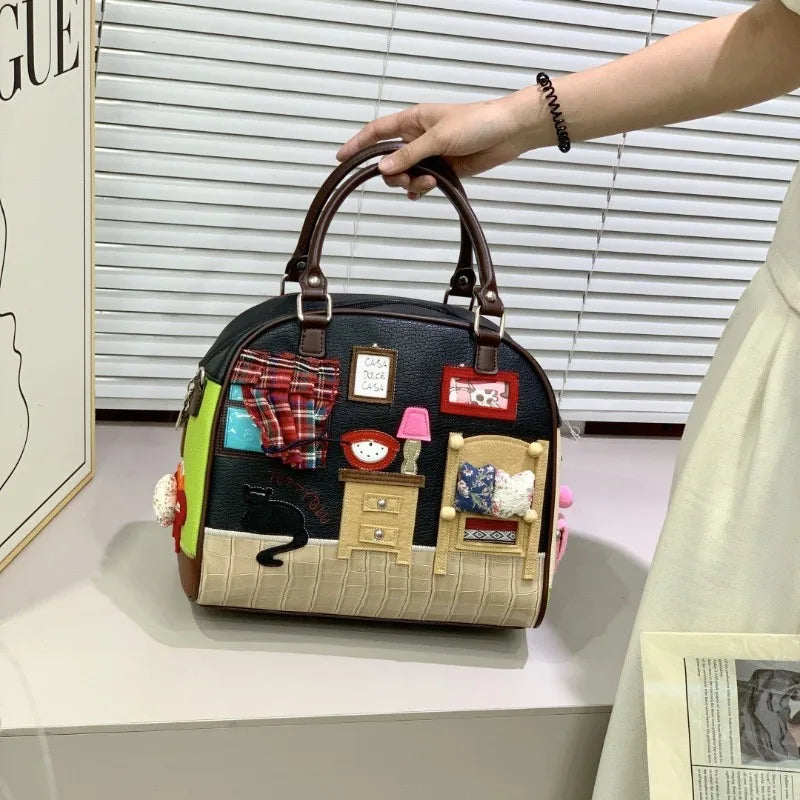 Handbag with miniature room design held by a person, with a window and blinds in the background.