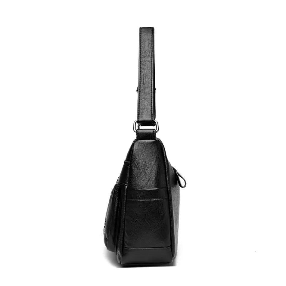 Black leather crossbody bag on a white background