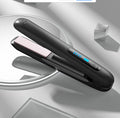 Wireless 2-in-1 hair straightener in black, open view showing ceramic plates and blue LED heat indicator on silver background