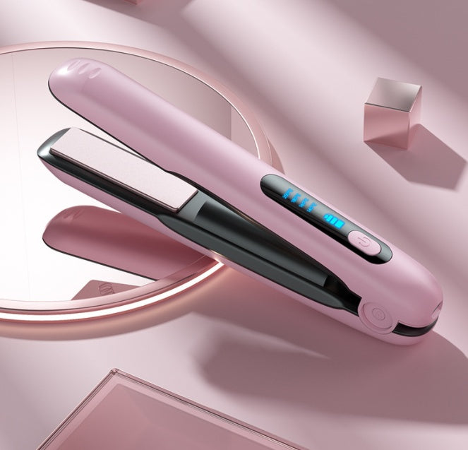 Wireless cordless flat iron in pink, open view showing ceramic plates and blue LED heat display on pink background