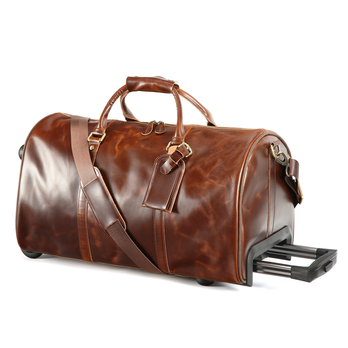 A brown leather duffel bag with a glossy finish, featuring dual top handles, a detachable shoulder strap, a luggage tag, and an extended black telescoping rolling handle, shown on a white background.