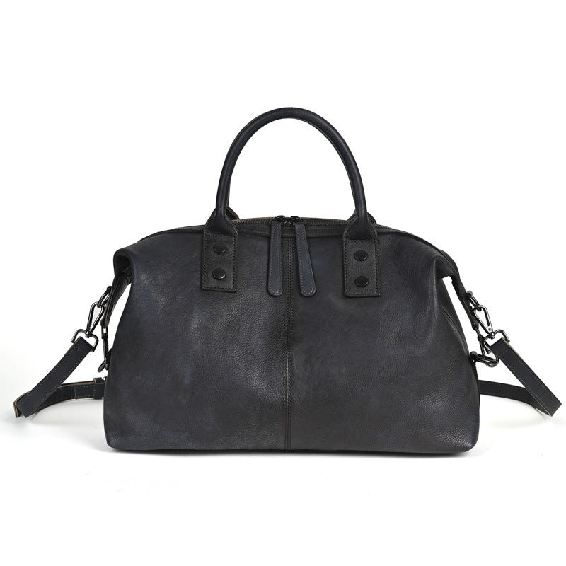 Women's retro genuine leather handbag in black, front view with zipper closure and adjustable crossbody strap