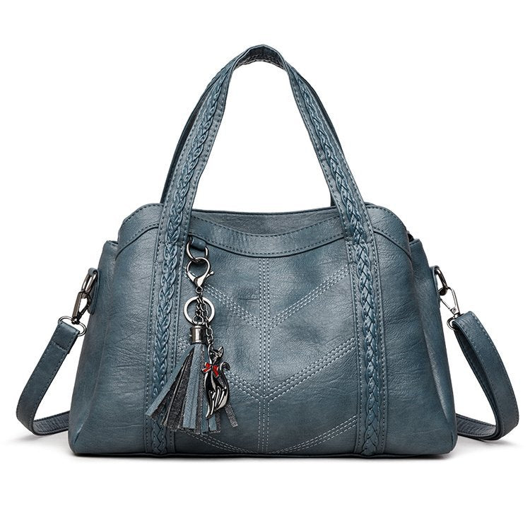 Blue handbag with a keychain on a white background