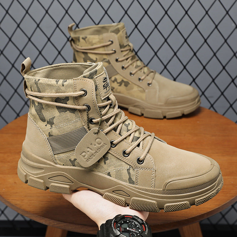 Tan tactical boots with camouflage pattern on a wooden surface and grid background