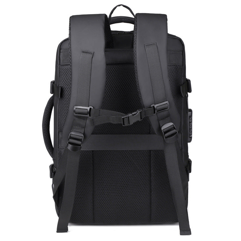 A black minimalist backpack with a top carry handle, side compression straps, and a front zippered pocket, shown against a clean white geometric background.