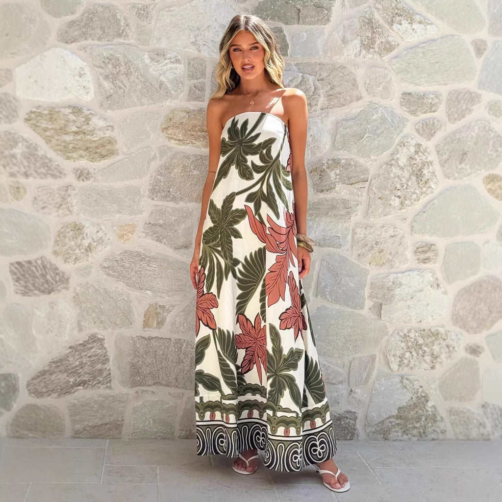 Woman wearing a floral strapless dress against a stone wall.