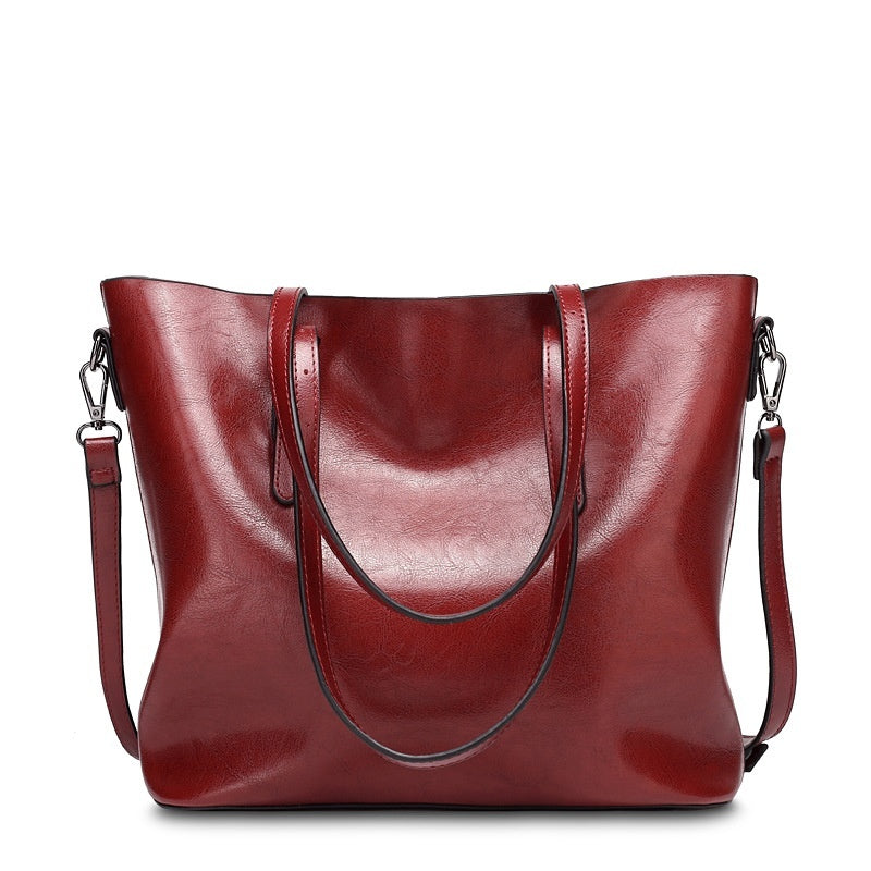 Women's retro oil wax leather tote bag in red, front view on white background with dual handles and detachable crossbody strap