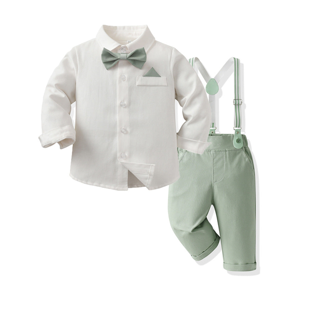 A baby boy's three-piece formal outfit set featuring a white long-sleeve shirt with a light sage green bow tie and pocket square, paired with sage green suspenders and matching pants, shown on a plain white background.