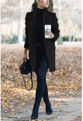 Person holding a Starbucks cup outdoors on a leafy path