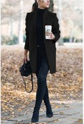 Person holding a Starbucks cup outdoors on a leafy path